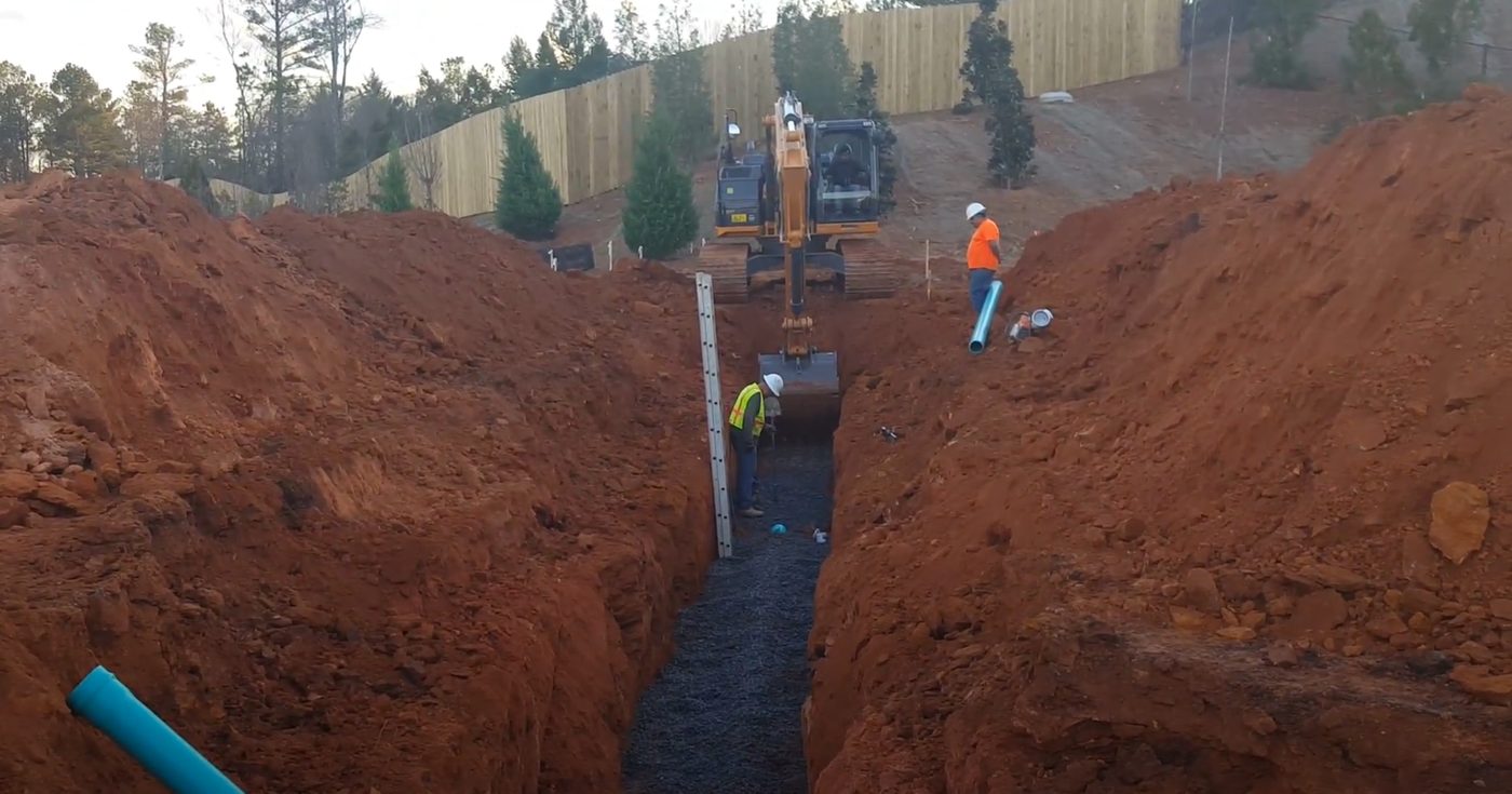Storm drain pipe and catch basin being installed